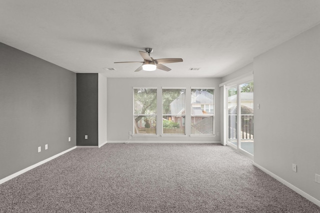 unfurnished room with a ceiling fan, carpet, and a healthy amount of sunlight