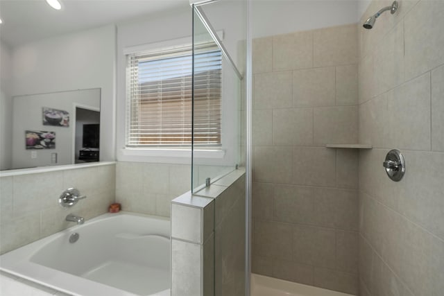 11310 Cora Ln, Willis, TX 77318 - full bathroom with a tile shower and a garden tub