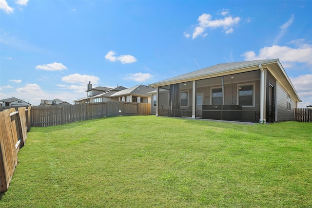 11310 Cora Ln, Willis, TX 77318 - rear view of house featuring a sunroom, a fenced backyard, and a yard