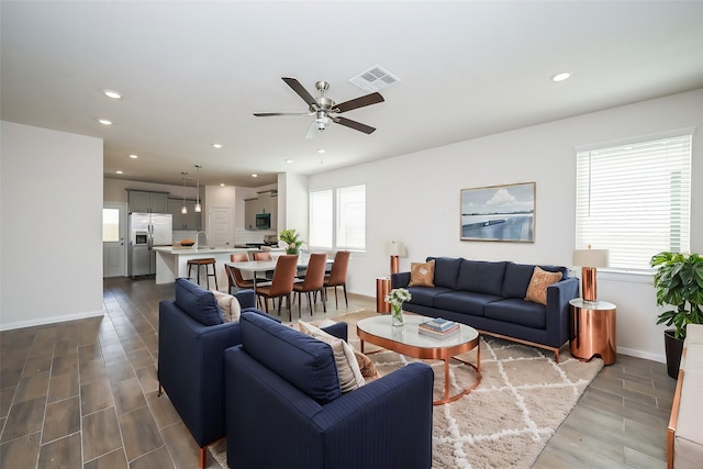 14515 Aston Pine Dr, Houston, TX 77032 - living room featuring visible vents, baseboards, ceiling fan, dark wood-style floors, and recessed lighting