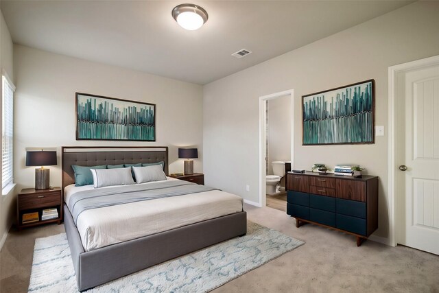 14515 Aston Pine Dr, Houston, TX 77032 - bedroom featuring baseboards, visible vents, ensuite bathroom, and light colored carpet
