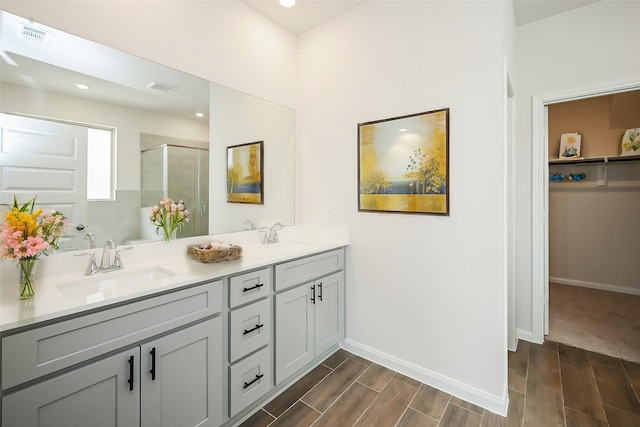 14515 Aston Pine Dr, Houston, TX 77032 - bathroom with double vanity, a sink, wood tiled floor, and a shower stall