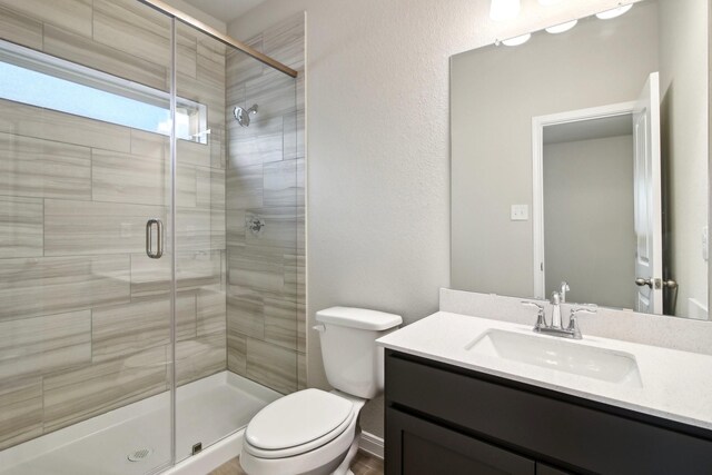 14515 Aston Pine Dr, Houston, TX 77032 - bathroom featuring toilet, a shower stall, and vanity