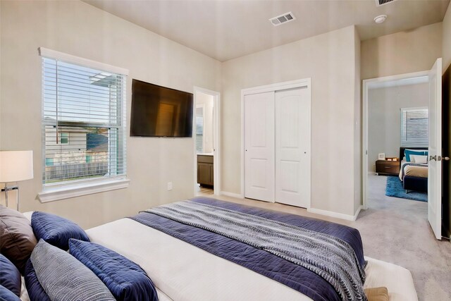 14515 Aston Pine Dr, Houston, TX 77032 - bedroom with visible vents, baseboards, light carpet, and a closet