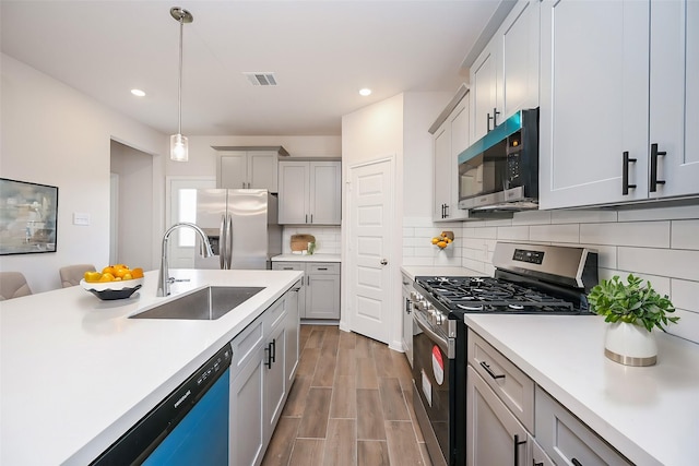 14515 Aston Pine Dr, Houston, TX 77032 - kitchen with a sink, light countertops, stainless steel appliances, recessed lighting, and visible vents