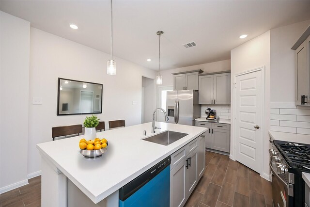 14515 Aston Pine Dr, Houston, TX 77032 - kitchen with visible vents, gray cabinets, tasteful backsplash, a sink, and stainless steel appliances