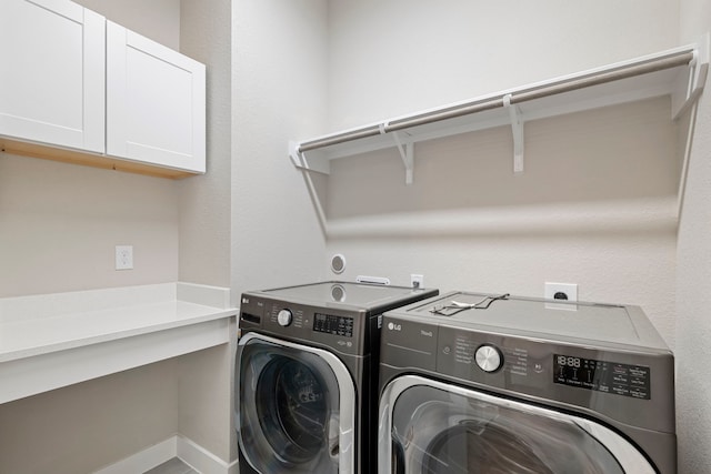 1220 Sloane Manor Trce, Houston, TX 77043 - clothes washing area with cabinet space and washing machine and clothes dryer