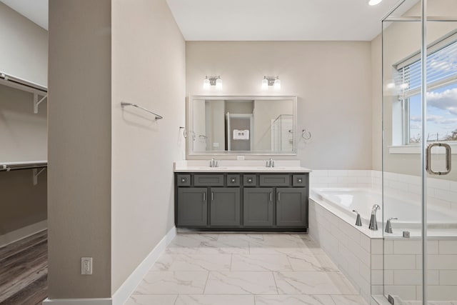 1220 Sloane Manor Trce, Houston, TX 77043 - bathroom with a sink, a walk in closet, a bath, and a stall shower