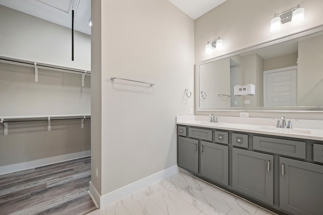 1220 Sloane Manor Trce, Houston, TX 77043 - full bath featuring a sink, baseboards, double vanity, and a walk in closet