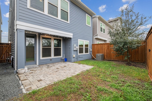 1220 Sloane Manor Trce, Houston, TX 77043 - back of property with central air condition unit, a patio, and a fenced backyard