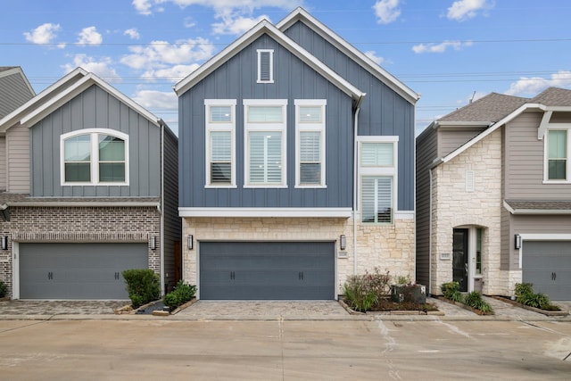 1220 Sloane Manor Trce, Houston, TX 77043 - view of front of home with a garage, board and batten siding, driveway, and stone siding