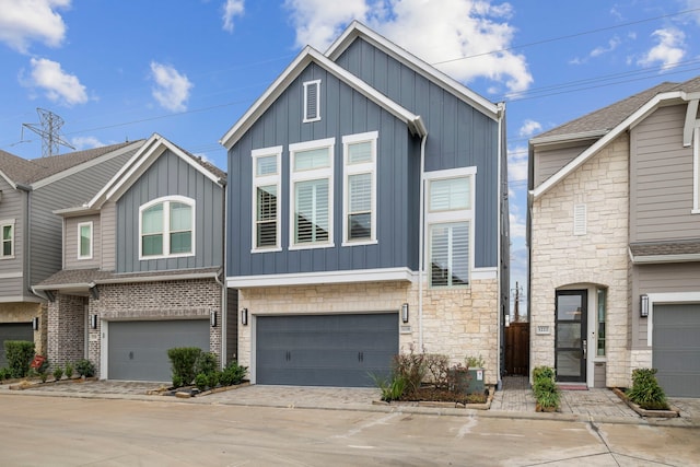1220 Sloane Manor Trce, Houston, TX 77043 - view of front of house featuring a garage, board and batten siding, driveway, and stone siding