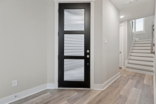 1220 Sloane Manor Trce, Houston, TX 77043 - entrance foyer featuring visible vents, baseboards, stairway, and light wood-type flooring