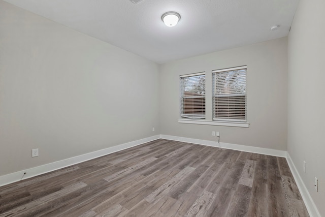 1220 Sloane Manor Trce, Houston, TX 77043 - empty room featuring baseboards and wood finished floors