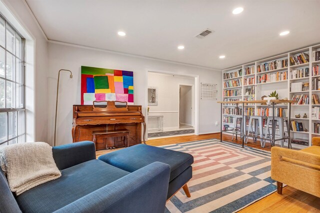 sitting room featuring recessed lighting, ornamental molding, wood finished floors, and visible vents