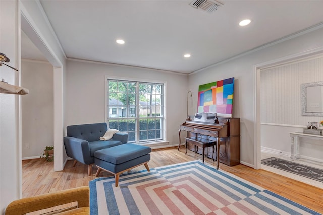 sitting room featuring visible vents, ornamental molding, wood finished floors, and recessed lighting