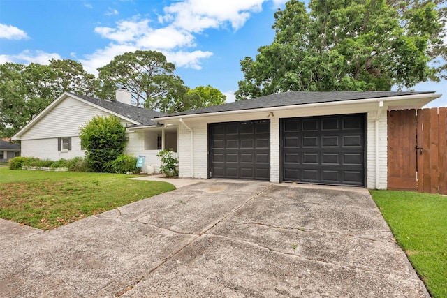 ranch-style house with brick siding, a garage, and driveway