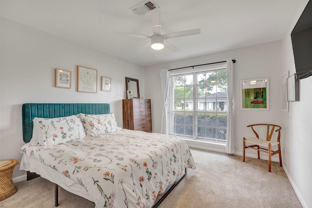 carpeted bedroom with baseboards, visible vents, and ceiling fan