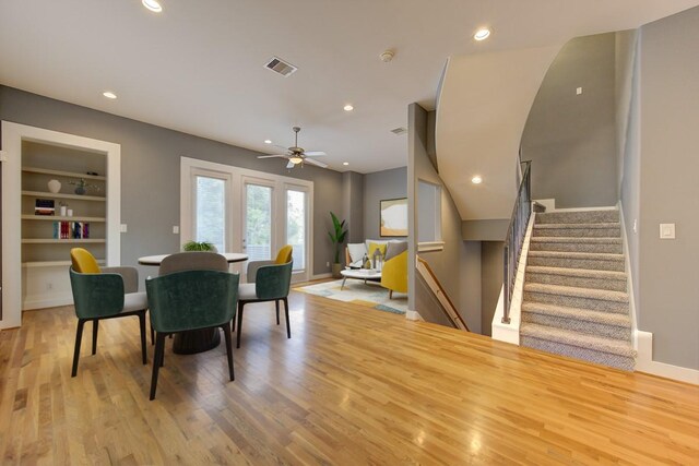dining area with visible vents, built in shelves, baseboards, recessed lighting, and light wood-style flooring