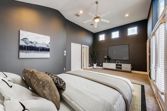 carpeted bedroom with visible vents, recessed lighting, baseboards, and high vaulted ceiling