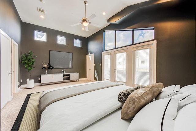 carpeted bedroom with high vaulted ceiling, access to exterior, and visible vents