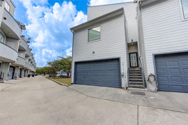 view of home's exterior featuring an attached garage and driveway