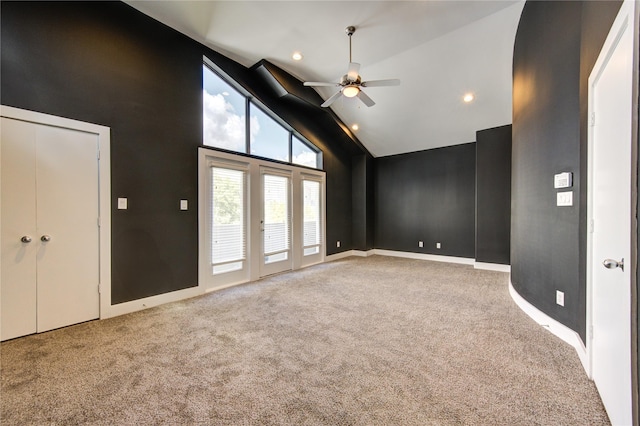 unfurnished living room featuring baseboards, ceiling fan, high vaulted ceiling, recessed lighting, and carpet flooring