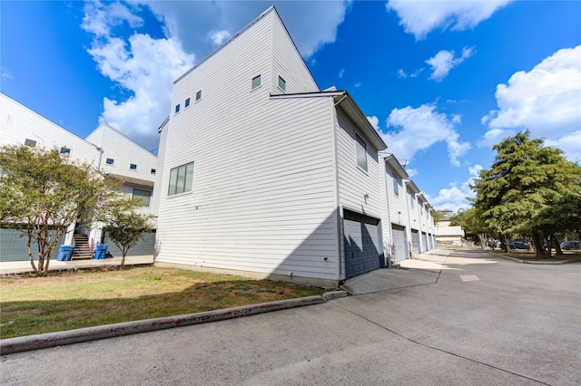 view of home's exterior featuring a garage and concrete driveway