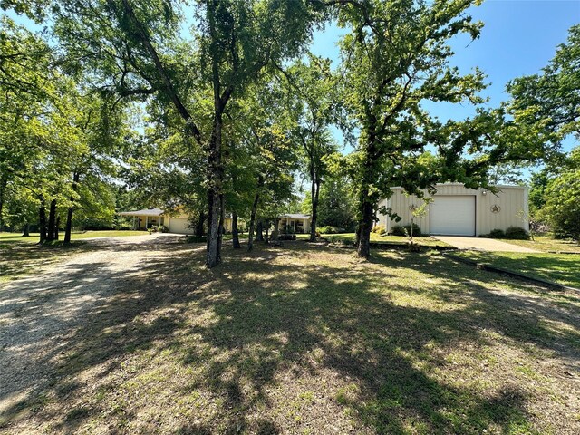 5325 County Road 2691, Buffalo, TX 75831 - view of yard with a detached garage, driveway, and an outdoor structure