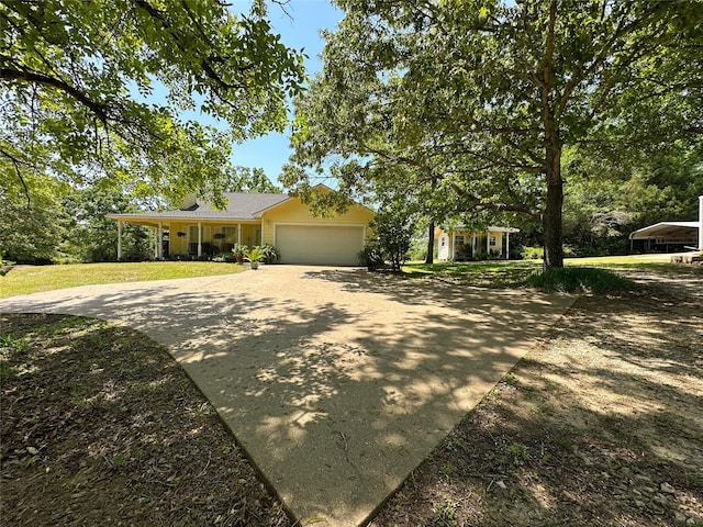 5325 County Road 2691, Buffalo, TX 75831 - view of front of house featuring an attached garage, driveway, and a front yard