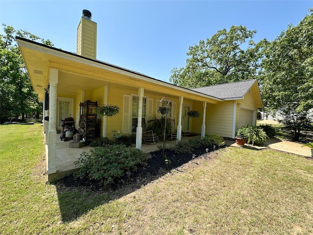 5325 County Road 2691, Buffalo, TX 75831 - exterior space with a shingled roof, an attached garage, a chimney, and a front yard