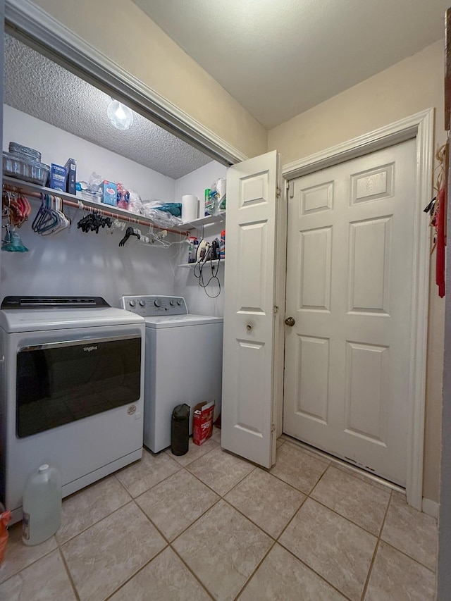 5325 County Road 2691, Buffalo, TX 75831 - laundry room featuring light tile patterned floors, laundry area, and washer and clothes dryer