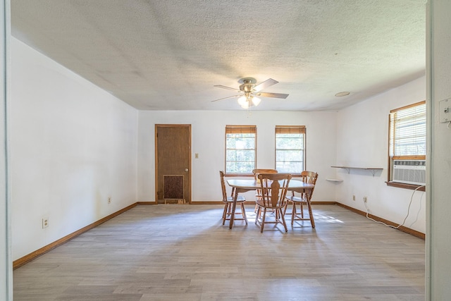 9847 N Lake Vw, Montgomery, TX 77316 - dining area with wood finished floors, cooling unit, ceiling fan, a textured ceiling, and baseboards