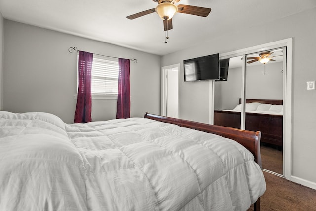 bedroom with ceiling fan, baseboards, carpet, and a closet