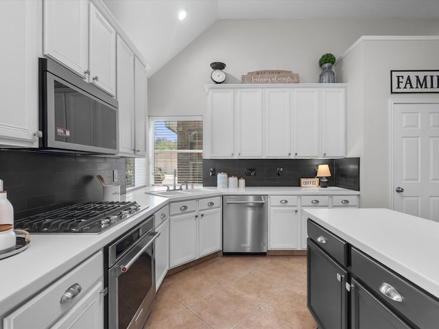 kitchen featuring light countertops, stainless steel appliances, white cabinetry, and a sink
