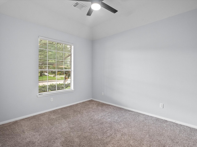 unfurnished room with carpet floors, baseboards, a ceiling fan, and visible vents