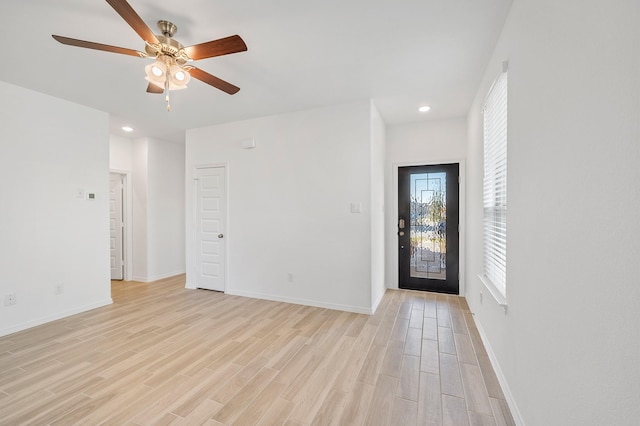 interior space featuring baseboards, a ceiling fan, recessed lighting, and light wood-style flooring