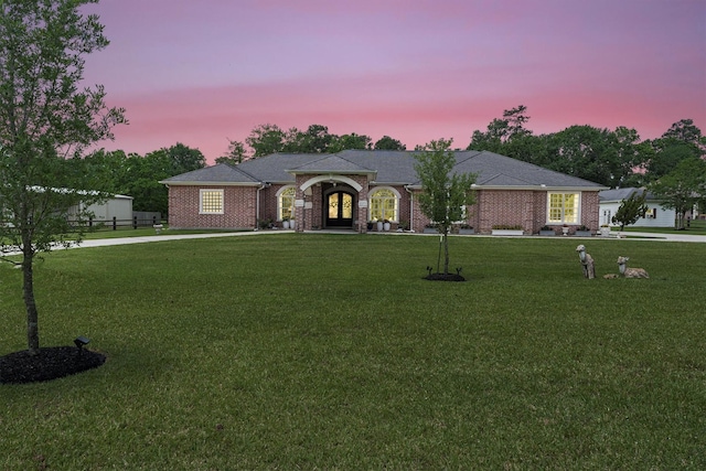 33519 Hillside Dr, Pinehurst, TX 77362 - view of front of property featuring a lawn, french doors, and brick siding