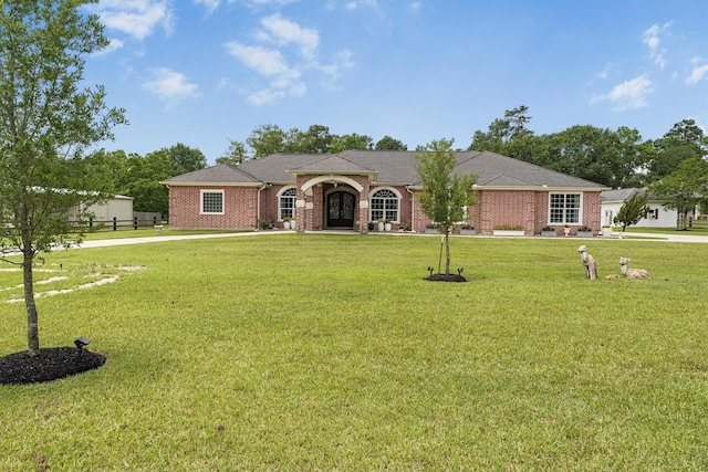 33519 Hillside Dr, Pinehurst, TX 77362 - view of front of house featuring a front yard and brick siding