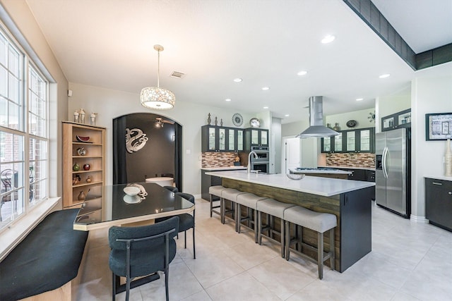 33519 Hillside Dr, Pinehurst, TX 77362 - kitchen featuring stainless steel appliances, island range hood, backsplash, plenty of natural light, and recessed lighting