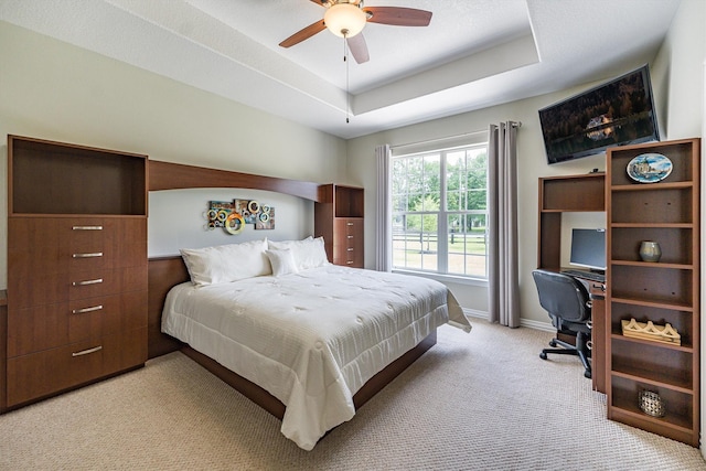 33519 Hillside Dr, Pinehurst, TX 77362 - bedroom featuring light colored carpet, an office area, a raised ceiling, baseboards, and a ceiling fan