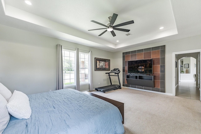 33519 Hillside Dr, Pinehurst, TX 77362 - carpeted bedroom with a tray ceiling, recessed lighting, baseboards, arched walkways, and a ceiling fan