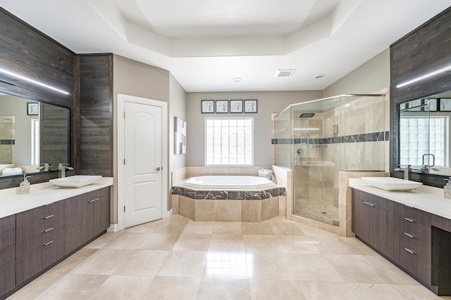 33519 Hillside Dr, Pinehurst, TX 77362 - bathroom with a garden tub, a stall shower, vanity, a tray ceiling, and tile patterned floors