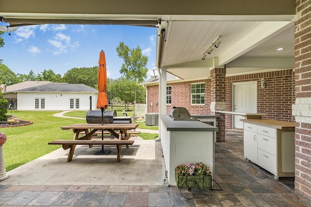 33519 Hillside Dr, Pinehurst, TX 77362 - view of patio with exterior kitchen, cooling unit, and outdoor dining area