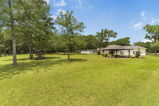 33519 Hillside Dr, Pinehurst, TX 77362 - view of yard featuring a gazebo, view of scattered trees, and a detached carport