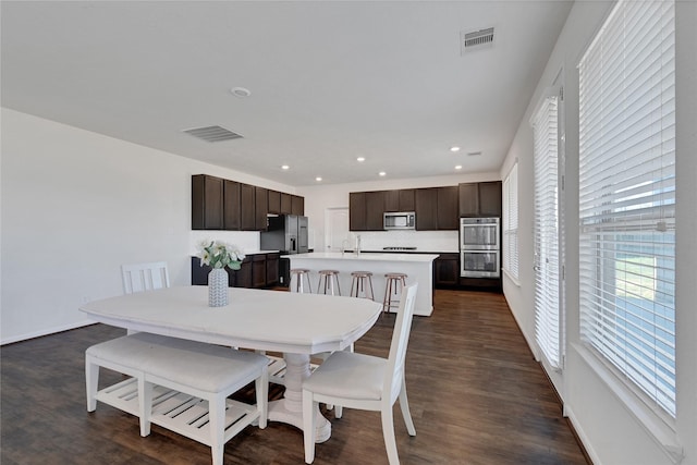 25553 Kensington Lake Dr, Porter, TX 77365 - dining room featuring visible vents, dark wood-style flooring, and a healthy amount of sunlight