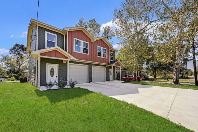 view of front facade with board and batten siding, driveway, central AC unit, a front lawn, and an attached garage