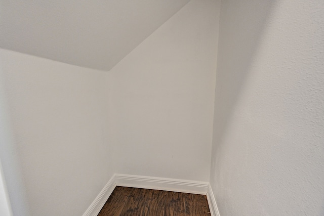 interior space featuring baseboards and wood finished floors