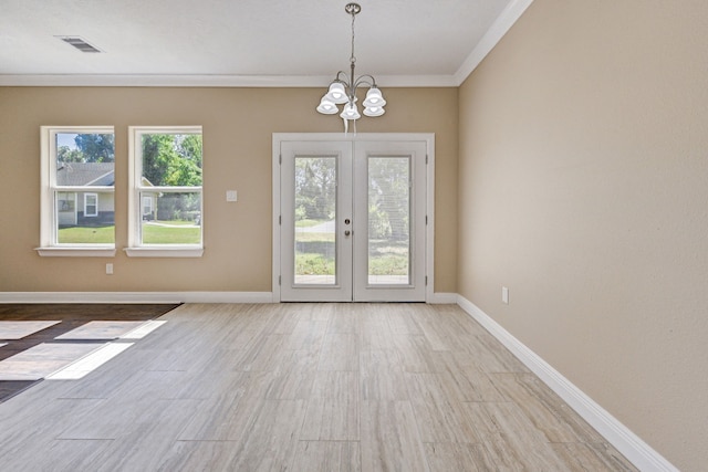 doorway with french doors, visible vents, crown molding, wood finished floors, and an inviting chandelier