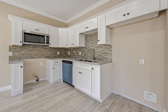 kitchen with white cabinets, a sink, dishwasher, stainless steel microwave, and decorative backsplash